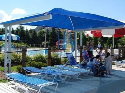Outdoor poolside area with loungers and canopy.
